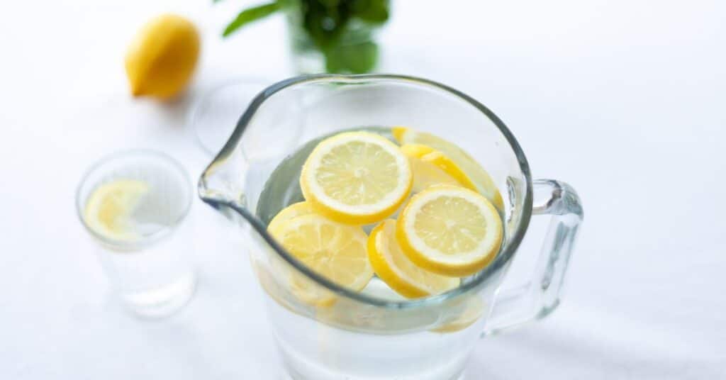 A pitcher of water filled with lemon slices