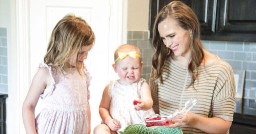 Katie Lovitt, registered dietitian makes a salad in the kitchen with her two kids, stop googling how to fix your digestive issues